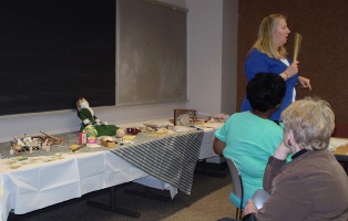 Lorraine demonstrates wooden toys of the 1860's.